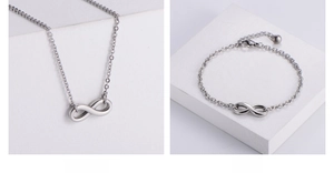 Macro detail of stainless steel infinity necklace and bracelet set with lobster clasp