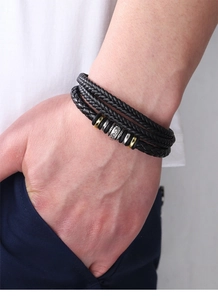 Close-up of men's multi-layer braided leather bracelet with wood and metal beads