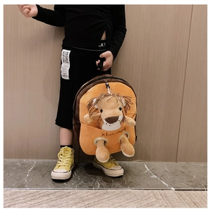 Detail of cute orange plush lion backpack with 3D animal design for toddlers