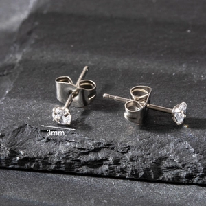 Macro side view of 3mm silver stainless steel stud earring with four-prong round zircon