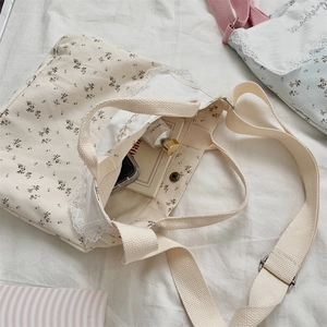 Close-up of floral canvas tote bag featuring lace trim and spacious interior storage