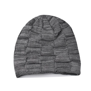 Detailed view of grey checkered knit beanie with thick fleece lining for winter warmth
