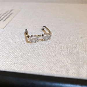 Detailed close-up of a silver Y2K glasses-shaped ring with polished finish and clear lenses