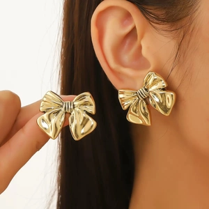 Elegant gold bow-knot stud earrings with polished metallic finish and textured design