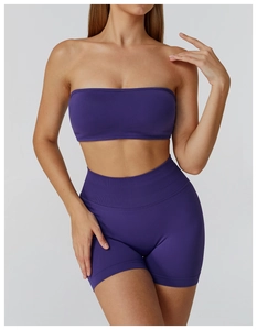 Detail of high-waist ribbed fitness shorts and tube top set in deep purple knit fabric