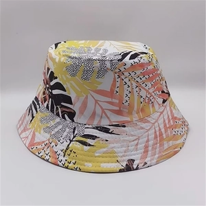 Reversible bucket hat with tropical leaf print in yellow, pink, black and white tones