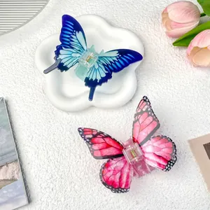 Elegant butterfly hair claw clips in blue and pink acrylic finish for stylish women