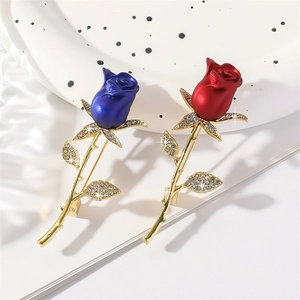 Elegant red and blue rose brooches with gold stems and sparkling crystal accents