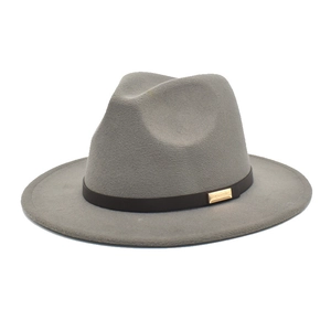 Detailed close-up of grey wool felt fedora hat featuring black leather band and gold buckle