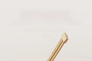 Macro detail of natural wood texture and reinforced cap for sofa cushion holder