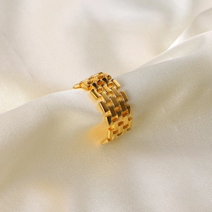 Wide 18K gold-plated stainless steel watchband link ring on soft beige silk background