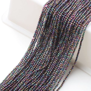 Close-up of 2mm faceted glass beads with rainbow metallic luster for DIY jewelry making