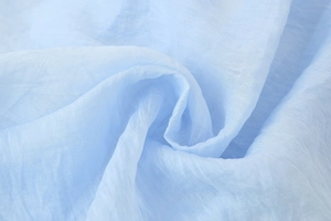 Close-up of the light blue ruffle top fabric showing the breathable textured texture