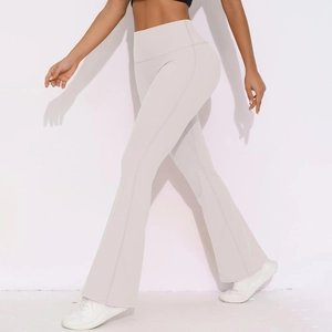 Detail of high waisted flared yoga leggings in beige showing fabric drape and fit