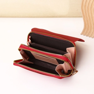 Detail view of red multi-functional wallet with double zipper and spacious inner compartments