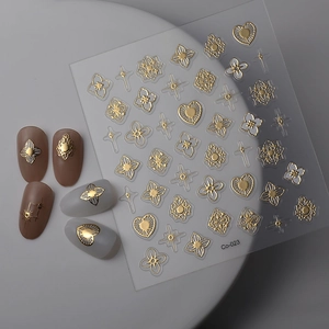 Macro detail of gold embossed nail stickers with floral patterns and star motifs on sheet