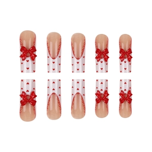 Long press-on nails with red 3D bows and heart patterns on nude pink French base