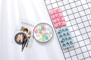 Close-up of pink and blue Christmas silicone molds with gingerbread and snowman shapes