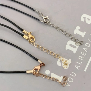 Three black wax leather cords with silver, gold, and rose gold lobster clasps and chains