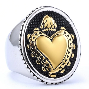 Retro mens stainless steel signet ring with gold crown heart over black texture