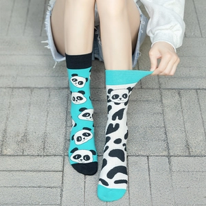 Detail of asymmetrical mid-calf cotton socks with panda prints and black dots on feet