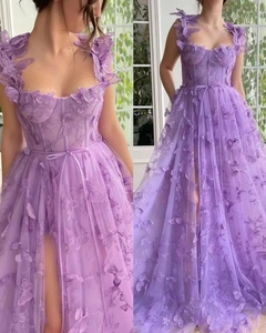 Detail of purple tulle dress with 3D butterfly appliqués and a sexy high side slit