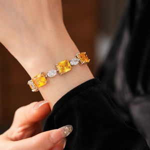 Detailed shot of silver bracelet featuring emerald-cut yellow zircons and white stones