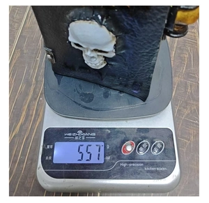 Gothic resin ghost book weighing 557g on a digital scale for weight confirmation