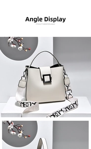 Close-up of white lychee grain bucket bag with black buckle and graffiti strap