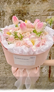 Detail of waterproof pink wrapping paper on a bouquet of pink tulips and roses