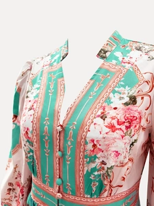 Detailed close-up of V-neckline and floral print on elegant mint green maxi dress