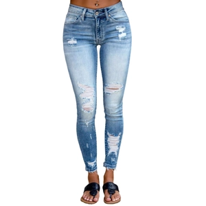 Women's trendy mid-rise skinny ripped jeans in classic medium blue wash denim style
