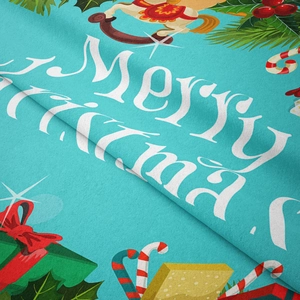 Macro shot of soft flannel Christmas fabric with Merry Christmas print and festive motifs