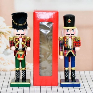 Pair of 10-inch wooden Nutcracker soldiers in plaid outfits with decorative gift box