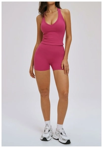 Detailed view of magenta halter neck sports bra and high-waisted fitness shorts set