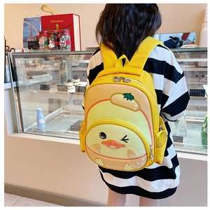 Detail of yellow 3D cartoon duck backpack with egg decor on girl student for school