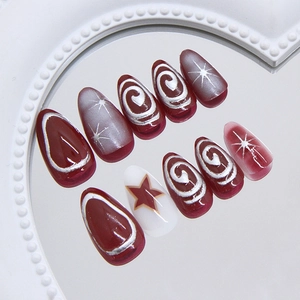 Press-on nails in burgundy and white with silver star art and spiral line patterns