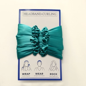 Macro detail of teal satin heatless hair curler set and matching hair scrunchies