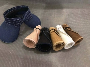 Rollable straw sun visors for women showing folding feature for easy travel storage