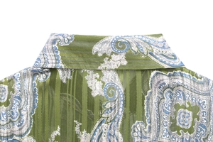 Detail of green paisley shirt featuring metallic silk striped texture and collar stitching