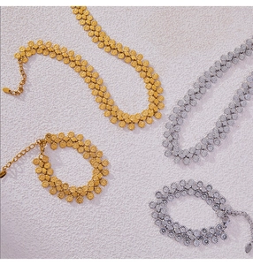 Detailed view of gold and silver sunburst flower disk necklace and bracelet jewelry sets