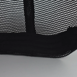 Close-up of the breathable black mesh material on the back of a plaid baseball cap