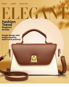 Detail of color-block tote bag showing elegant leather texture and golden metal rotary lock