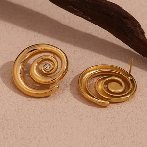 Close-up of 18K gold plated spiral earrings featuring micro-set zircon on rustic wood