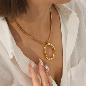 Elegant gold stainless steel snake chain necklace with a hollow oval pendant for women