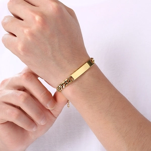 Close-up of gold-plated titanium steel Cuban chain bracelet with engravable ID plate