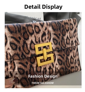Close-up of leopard print clutch with golden geometric metal buckle and leather texture