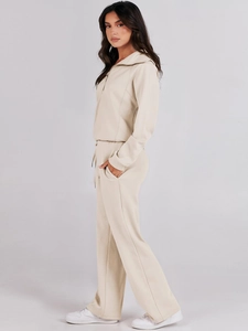 Detail of apricot lounge set featuring half-zip collar and wide-leg cotton pants texture