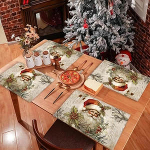 Festive Christmas table mats set with vintage Santa Claus patterns on a wooden dining table