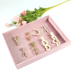 Pink velvet display tray with gold alloy hairpins featuring pearls and rhinestones